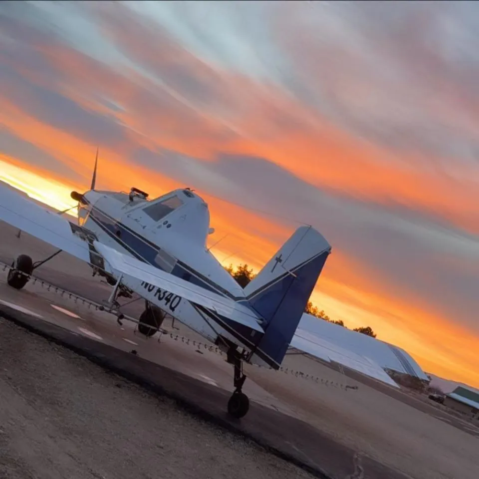 An Agri-Land Aviation aircraft at sunset